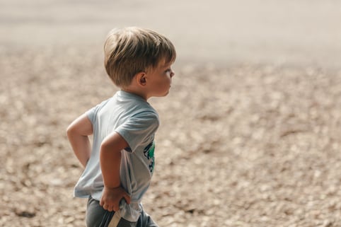 little-blond-boy-running-holding-his-pants-up